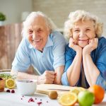 46149837 – happy senior man and woman looking at camera in the kitchen