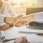 Business people shaking hands. Finishing up meeting.