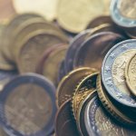 Euro coins close up. Scattered money with shallow depth of field.