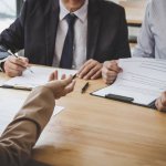 Business woman explaining about his profile to two selection com